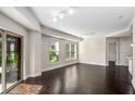 Bright and open living area, hardwood floors, balcony doors, and windows offering ample natural light at 200 River Vista Dr # 205, Atlanta, GA 30339