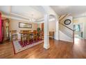 Elegant dining room features hardwood floors, a classic chandelier, and archway to living area at 4790 Maristone Landing Way, Cumming, GA 30040
