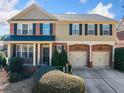 Charming two-story home with a brick facade, complemented by black shutters and a well-kept lawn at 4790 Maristone Landing Way, Cumming, GA 30040