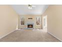 Bright living room with a fireplace and large windows overlooking the yard at 82 Austin Bridge Ln, Douglasville, GA 30134