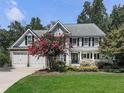Traditional two-story home featuring a manicured front lawn, a two-car garage, and welcoming curb appeal at 1012 Jubilee Way, Powder Springs, GA 30127