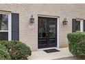 Close-up of the double front doors, address, and exterior lighting, surrounded by lush landscaping at 2795 Kakki Ct, Marietta, GA 30062