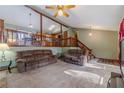 Inviting living room with vaulted ceiling, exposed beams, and open access to the dining and kitchen areas at 715 Wallington Way, Lawrenceville, GA 30046