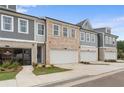 Attractive townhomes featuring a brick facade, attached garages, and neat landscaping, highlighting community living at 1024 Rose Dr, Marietta, GA 30060