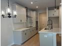 Modern kitchen with sleek countertops, stainless steel appliances, a stylish chandelier, and a central island at 1024 Rose Dr, Marietta, GA 30060