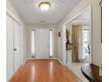 Inviting foyer with hardwood floors, white door, and natural light at 1256 Melrose Forrest Ln, Lawrenceville, GA 30045