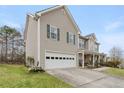 Two-story home with an attached garage and a well-maintained lawn at 1256 Melrose Forrest Ln, Lawrenceville, GA 30045