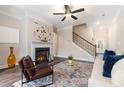 Cozy living room with fireplace, ceiling fan, and staircase at 1508 Burberry Aly, Marietta, GA 30008