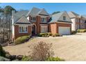 Inviting brick residence with a two-car garage, tasteful landscaping, and a meticulously maintained front lawn at 2986 Nestle Creek Dr, Marietta, GA 30062