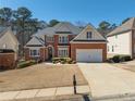 A well-maintained two-story home with a brick facade, a two-car garage, and a neatly kept front yard at 2986 Nestle Creek Dr, Marietta, GA 30062