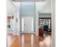 Bright foyer featuring hardwood floors, a high ceiling, and natural light streaming through the sidelight windows at 69 New Brunswick Ct, Suwanee, GA 30024