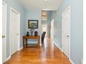 Inviting hallway featuring hardwood floors, fresh paint, and easy access to other rooms at 69 New Brunswick Ct, Suwanee, GA 30024