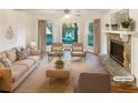 Bright living room with neutral furniture, fireplace, large windows, and hardwood floors at 4396 Shelley Nw Ln, Lilburn, GA 30047