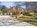 Two-story brick home with a two-car garage, walkway and driveway and landscaped yard at 663 Foxcroft Circle Se, Marietta, GA 30067