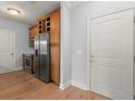 Kitchen with stainless steel appliances, wood cabinets, wine rack, and hardwood floors at 901 Abernathy Ne Rd # 3220, Sandy Springs, GA 30328