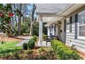 Cozy front porch with seating and manicured landscaping creating curb appeal at 436 Carolwood Ln, Atlanta, GA 30342