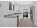 Well-lit kitchen featuring granite countertops, stainless steel appliances, and ample cabinet space at 815 Oxford Hall Dr, Lawrenceville, GA 30044