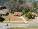 Aerial view of a home with a long driveway and green trees on a large lot at 131 Tye St, Stockbridge, GA 30281