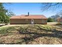 View of the rear of the house and backyard featuring a brown roof, and brown exterior at 131 Tye St, Stockbridge, GA 30281