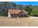 Cozy single-story home with a front porch, manicured shrubs, and a well-kept lawn at 131 Tye St, Stockbridge, GA 30281