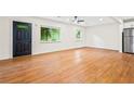 Bright living room with hardwood floors, fresh paint, a ceiling fan, and windows offering natural light at 3113 Bellgreen Way, Decatur, GA 30032