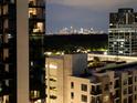 A stunning city skyline at night with lights, as viewed from a high-rise building at 3481 Lakeside Ne Dr # 1705, Atlanta, GA 30326