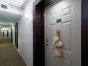 Hallway view of the unit entrance featuring a decorated door with a door number: 1705 at 3481 Lakeside Ne Dr # 1705, Atlanta, GA 30326