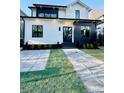 Beautiful modern home with a white exterior, black trim, and a well-manicured front yard at 904 Kings Ne Ct, Atlanta, GA 30306