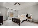 Serene main bedroom with tray ceiling, large window, and carpeted flooring at 1605 Loblolly Ln, Cumming, GA 30041