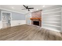 Inviting living room featuring a brick fireplace and built-in shelving units at 3900 Millwood Lane Nw, Lilburn, GA 30047