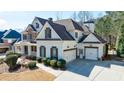 Angle view of a beautiful two-story home featuring a two-car garage, well-manicured landscaping, and inviting curb appeal at 4978 Millwood Dr, Canton, GA 30114