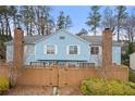 Charming exterior view of townhouse with fenced yard, shrubbery, and mature trees at 5555 Clover Rise Ln, Norcross, GA 30093