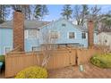 Exterior of townhouse with fenced-in backyard, mature trees, and a well-maintained lawn at 5555 Clover Rise Ln, Norcross, GA 30093