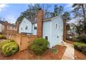 Exterior of townhouse with fenced-in backyard, mature trees, and a well-maintained lawn at 5555 Clover Rise Ln, Norcross, GA 30093