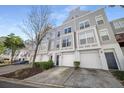 Desirable townhome showcases a well-kept exterior, attached garage, and attractive curb appeal at 1204 Village Se Ct, Atlanta, GA 30316