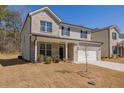 Charming two-story home featuring a brick and siding exterior, two-car garage and well-manicured lawn at 325 Caledonia Court Ct, Peachtree City, GA 30269