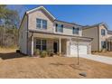 Charming two-story home with brick accents, a covered front porch, and a well-maintained lawn at 325 Caledonia Ct, Peachtree City, GA 30269