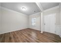 A serene room featuring neutral paint, wood floors, crown moulding, and lots of natural light at 72 Summer Nw Pl, Cartersville, GA 30121