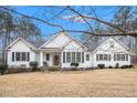 Charming single Gathering home featuring a white exterior, black shutters, and a well maintained lawn at 9369 Kraft Dr, Winston, GA 30187