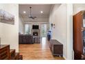 Spacious living room with hardwood floors, stone fireplace, ceiling fan, and neutral paint at 9369 Kraft Dr, Winston, GA 30187