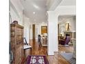 Grand foyer with hardwood floors, elegant columns, and views into the living room at 1059 Hedge Rose Ne Ct, Atlanta, GA 30324