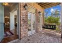 Charming front porch with brick flooring, swing, and double French doors at 1059 Hedge Rose Ne Ct, Atlanta, GA 30324