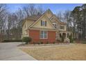 Charming two-story home with brick and stone, manicured landscaping, and a spacious driveway leading to the side-entry garage at 1554 Sage Ridge Dr, Marietta, GA 30064