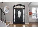 A foyer with a dark-stained front door, decorative sidelights and transom, and a view of the staircase at 1554 Sage Ridge Dr, Marietta, GA 30064