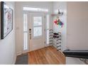 Bright entryway featuring light wood floors, white walls, a white door, and organized storage and decor at 2426 Vivian Cir, Decatur, GA 30030