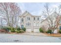 Charming two-story home with attached garage, detailed architectural trim, arched windows, and well-maintained landscaping at 2426 Vivian Cir, Decatur, GA 30030