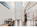 Grand foyer with high ceilings, dark hardwood floors, and abundant natural light from the arched window at 3865 Brookhollow Dr, Douglasville, GA 30135