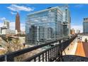 Rooftop view of city with glass and steel buildings, blue sky, and distant traffic at 115 W Peachtree Nw # 405, Atlanta, GA 30313