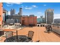 Expansive rooftop terrace offers city views and seating areas for relaxing and entertaining at 115 W Peachtree Nw # 405, Atlanta, GA 30313