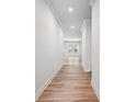 Inviting hallway with hardwood floors and neutral walls leading to bright living spaces at 147 Park Lane Ln, Fairburn, GA 30213